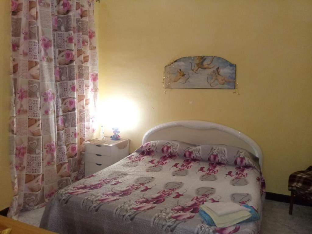 a bedroom with a bed with a bedspread with dolls on it at CASA DI CARLO in Naples