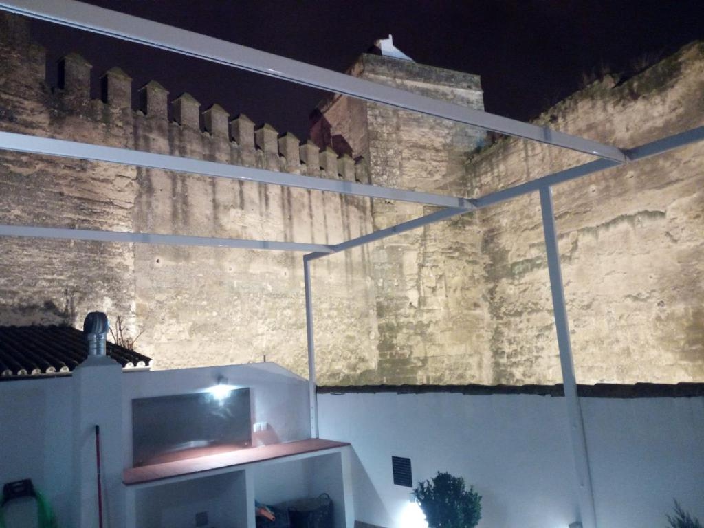 a building with a brick wall and a white cabinet at APARTAMENTO PUERTA SEVILLA in Carmona