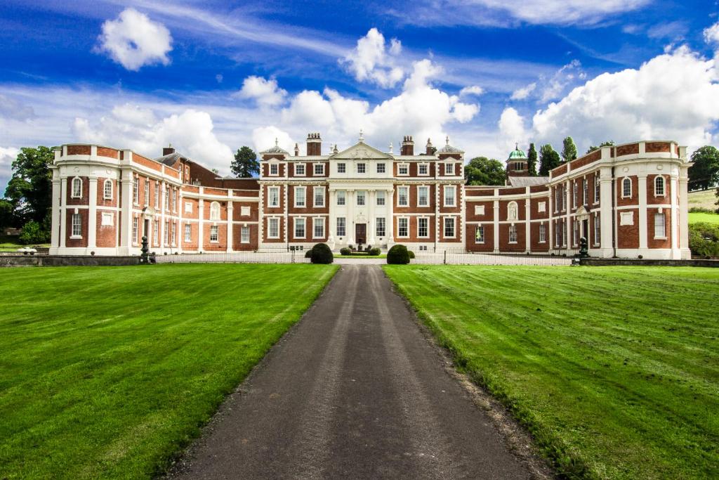 a large mansion with a grass field in front of it at Hawkstone Hall Hotel & Gardens in Shrewsbury