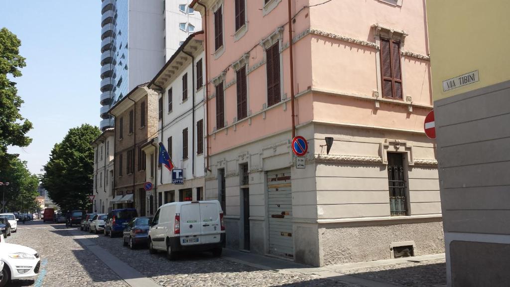 a white van parked on a street next to a building at Hotel Astor in Piacenza