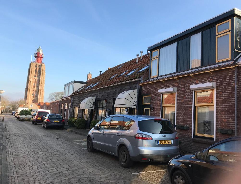 a car parked on a street next to a building at Hotel Pieter de Coninck in Westkapelle