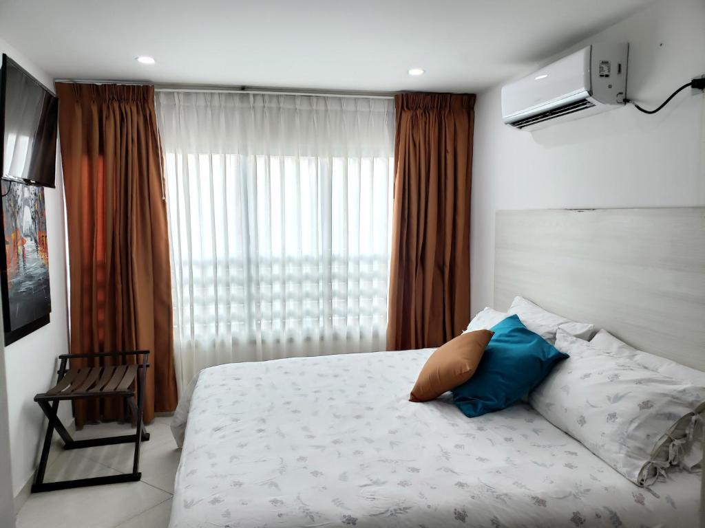 1 dormitorio con 1 cama grande y ventana en Hotel Radoa en El Banco