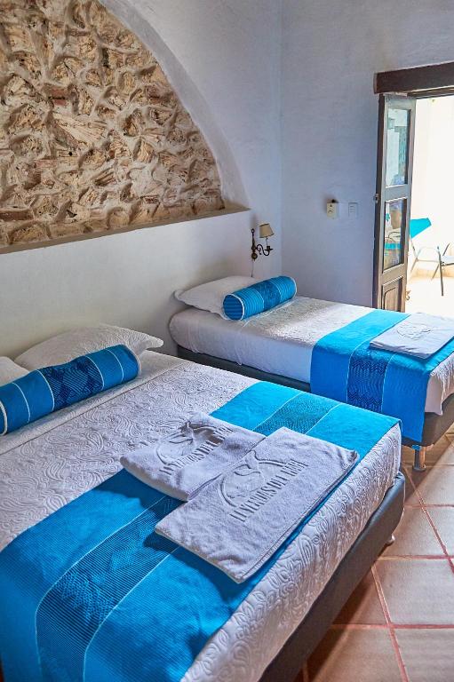 Postel nebo postele na pokoji v ubytování Cartagena Legends