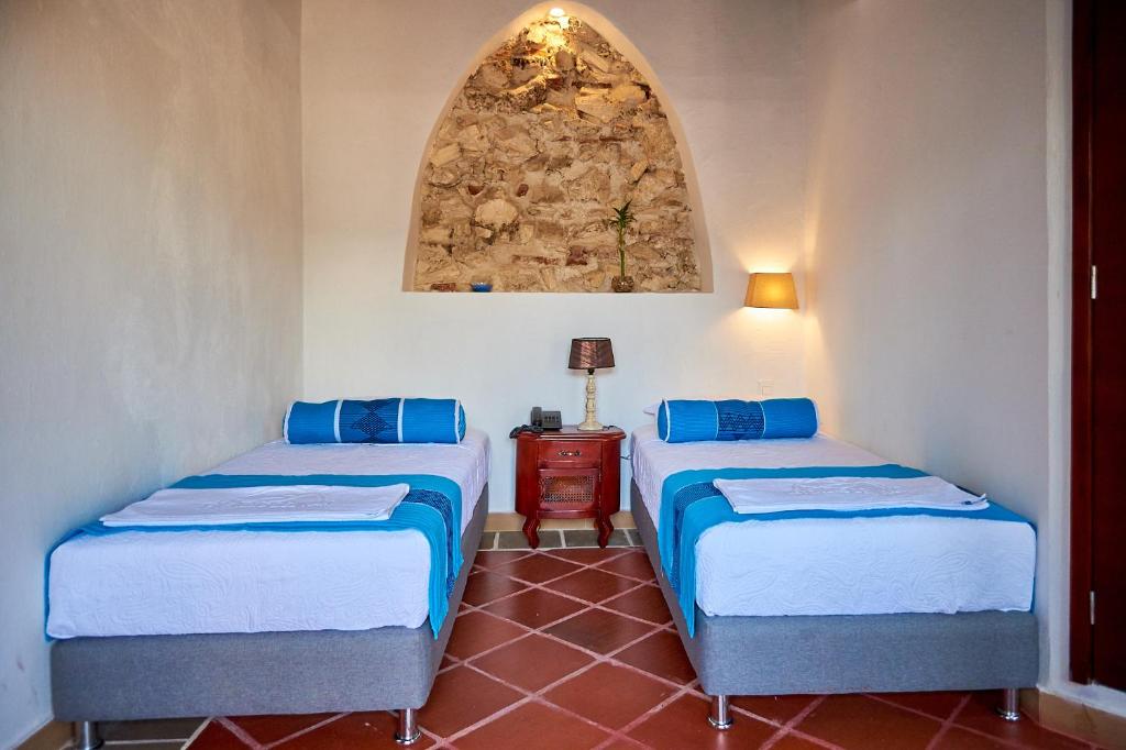 Postel nebo postele na pokoji v ubytování Cartagena Legends