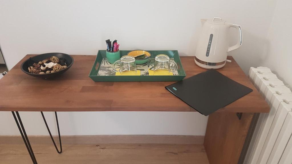 a wooden table with a tray of food on it at Villa Manoe in Draguignan