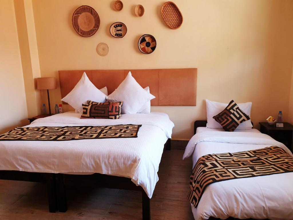 Postel nebo postele na pokoji v ubytování Acacia Tree Lodge