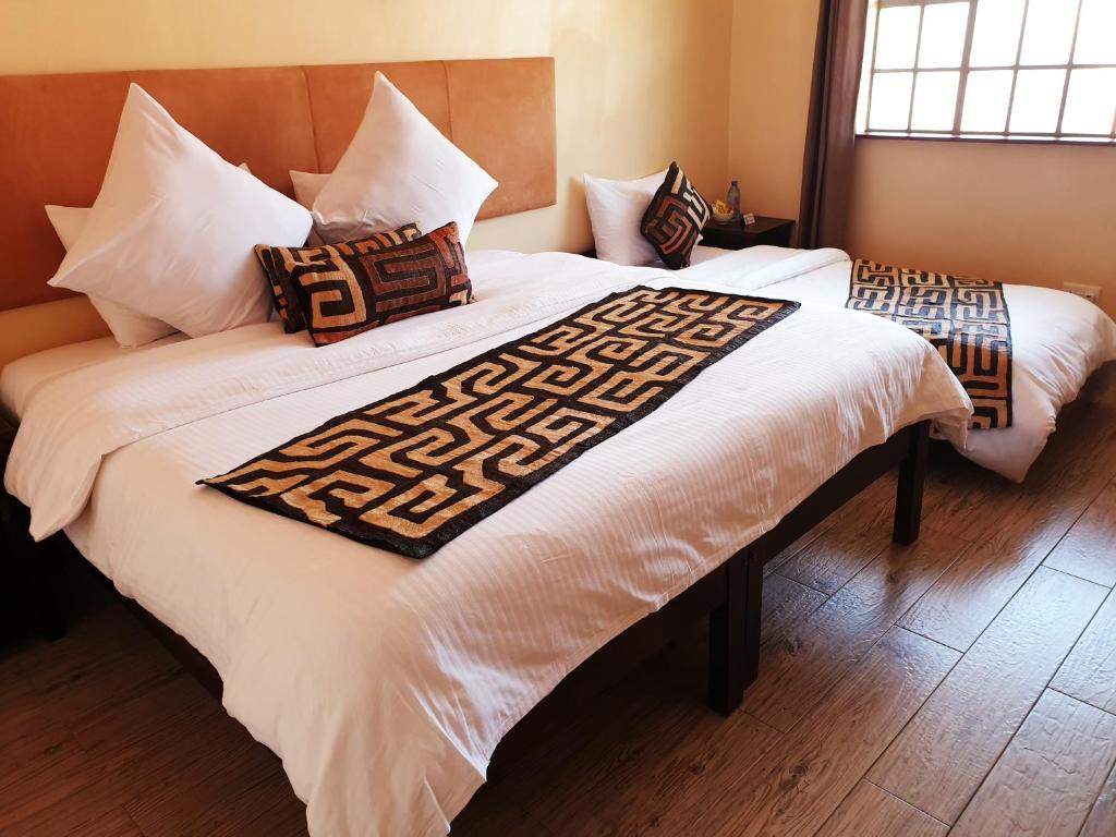 Postel nebo postele na pokoji v ubytování Acacia Tree Lodge