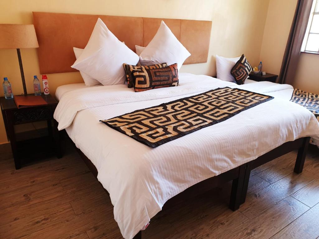 Postel nebo postele na pokoji v ubytování Acacia Tree Lodge