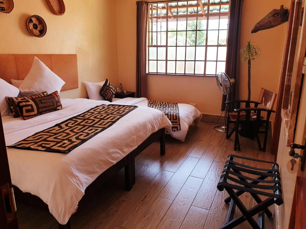 Postel nebo postele na pokoji v ubytování Acacia Tree Lodge