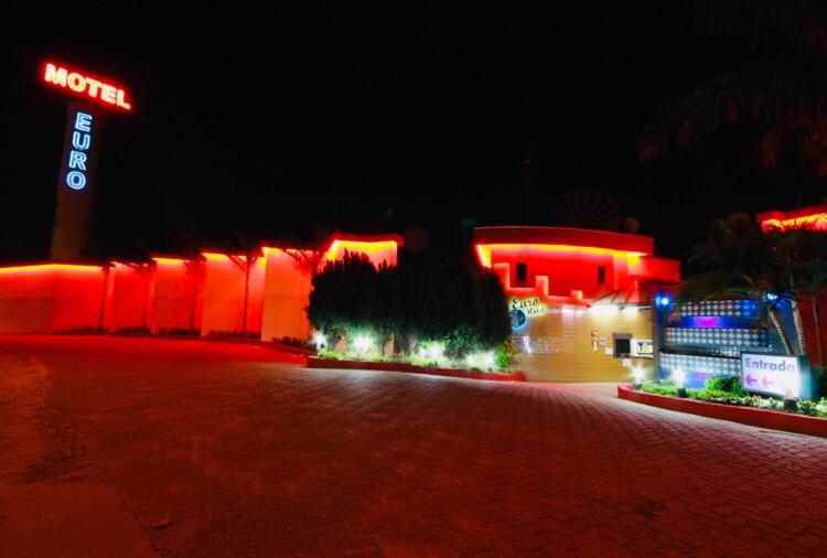 a night view of a hotel with red lights at Euro Motel (Only Adults) in Viracopos