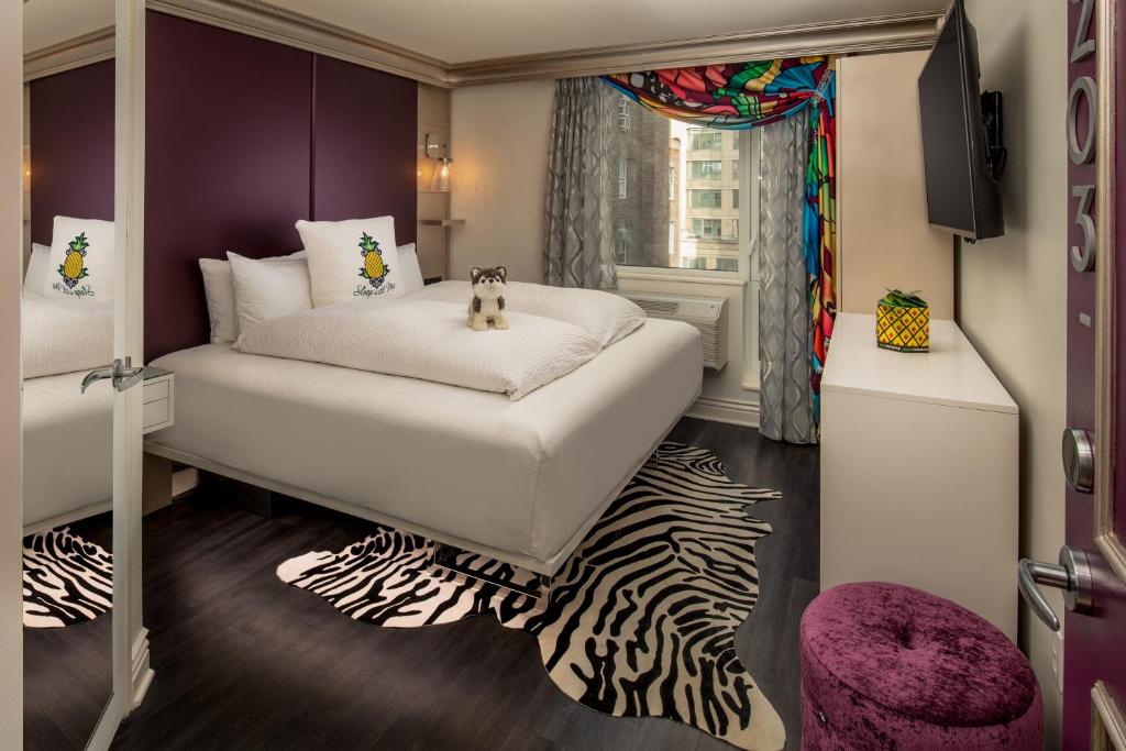 a bedroom with a bed and a dresser at Staypineapple, An Artful Hotel, Midtown New York in New York