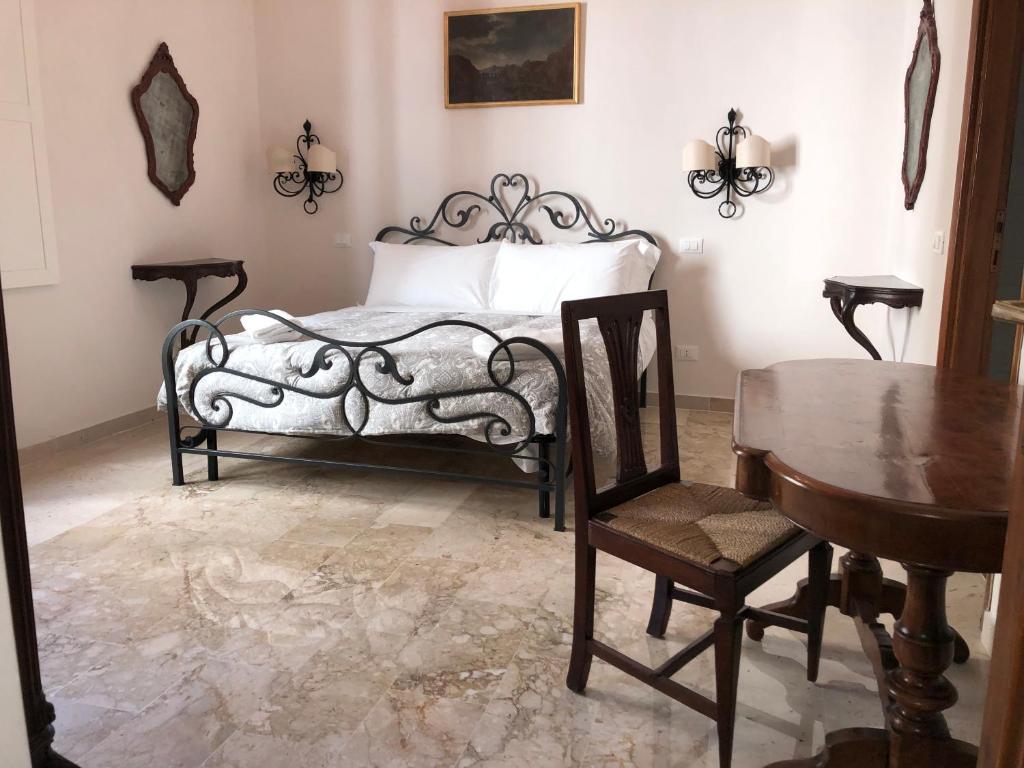 a bedroom with a bed and a table and chairs at Viola Borgia in Florence