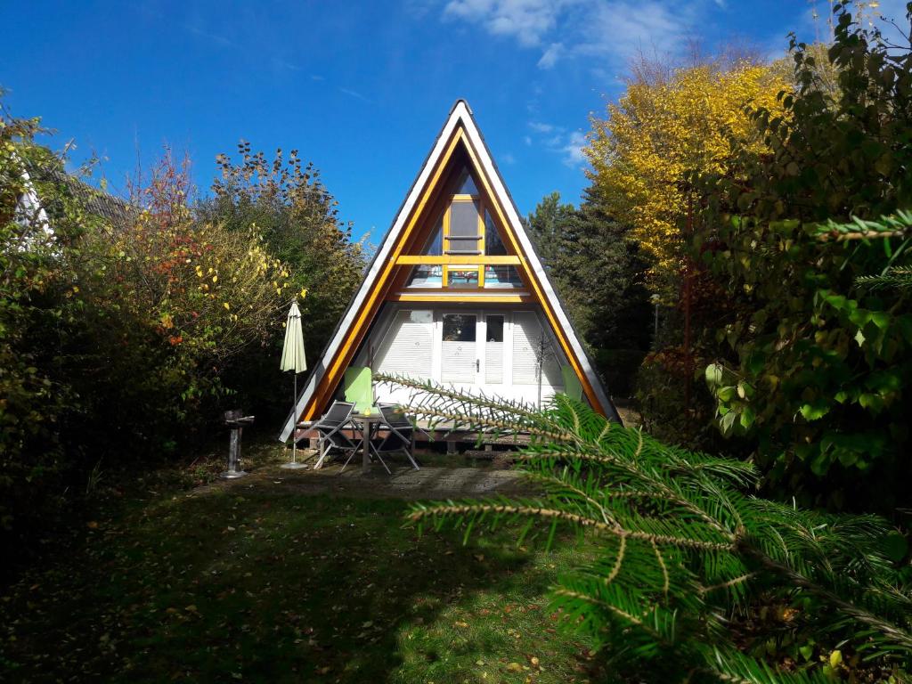 a frame house in the middle of a garden at Nurdachhaus Ferienpark Schellbronn in Schellbronn