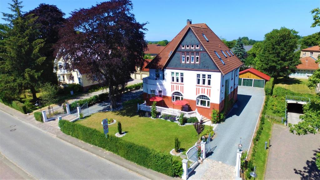 a large white house with a brown roof at Rosen Villa in Kappeln