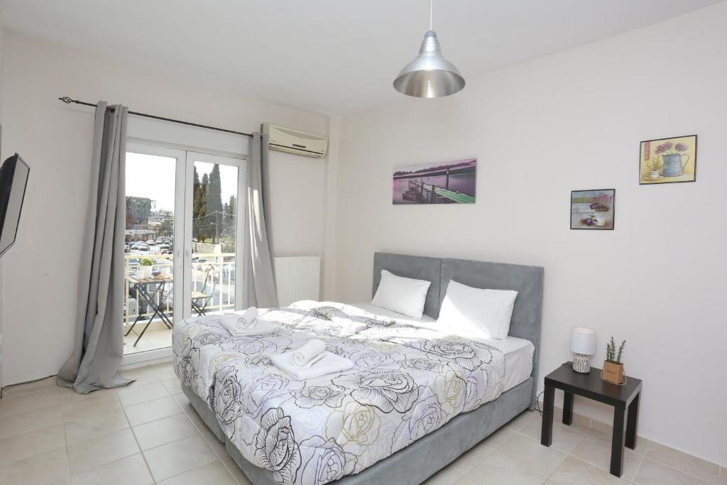 a bedroom with a bed and a balcony at Pantheon City Center Studio in Thessaloniki