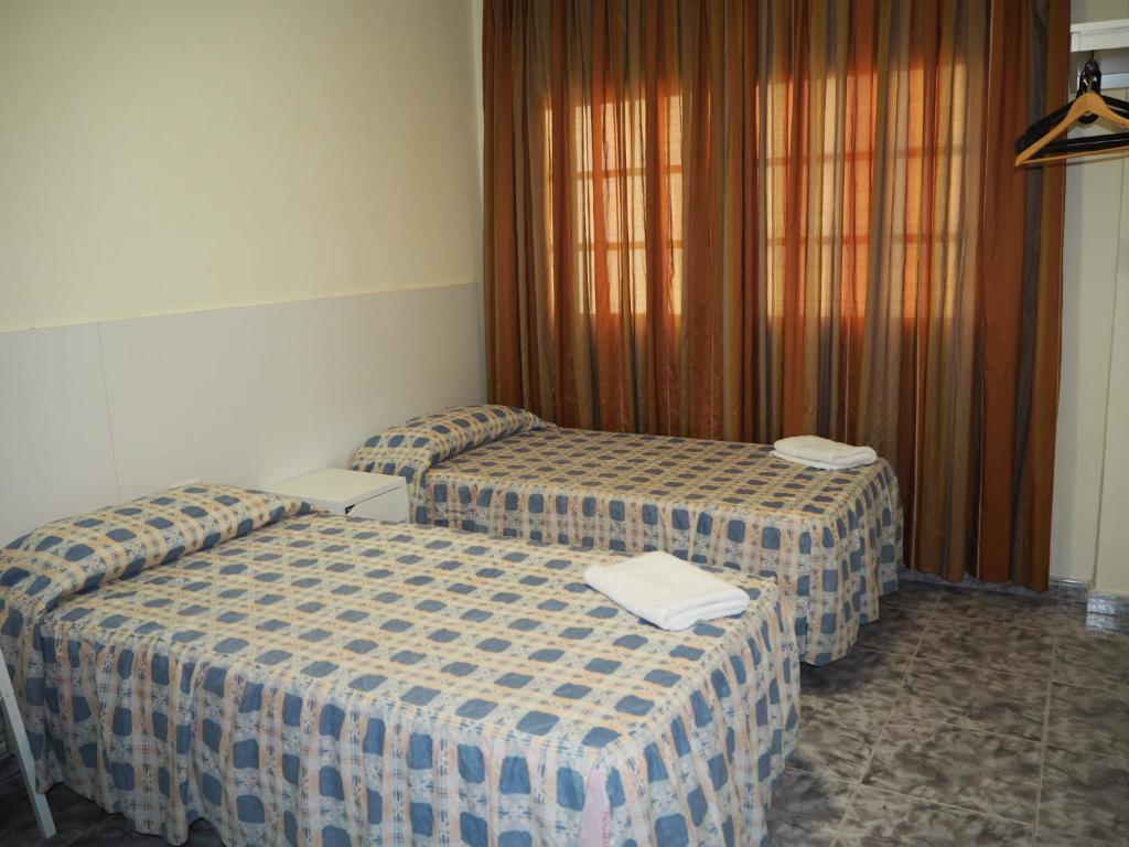 A bed or beds in a room at apartamentos la villa 2