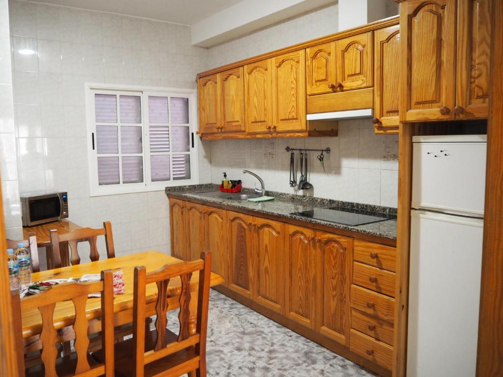 A kitchen or kitchenette at apartamentos la villa 2