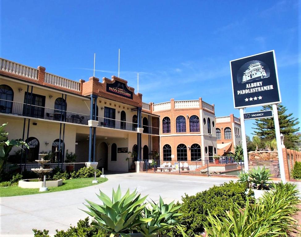 a large building with a sign on the side of it at Albury Paddlesteamer Motel in Albury