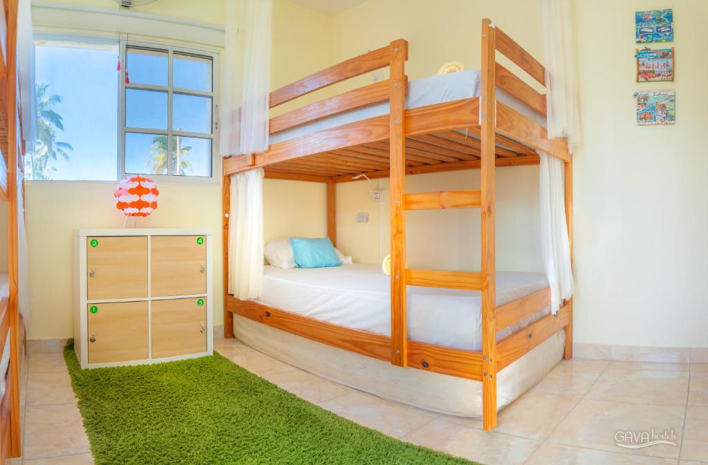a bedroom with two bunk beds and a ladder at GAVA hostel in Punta Cana