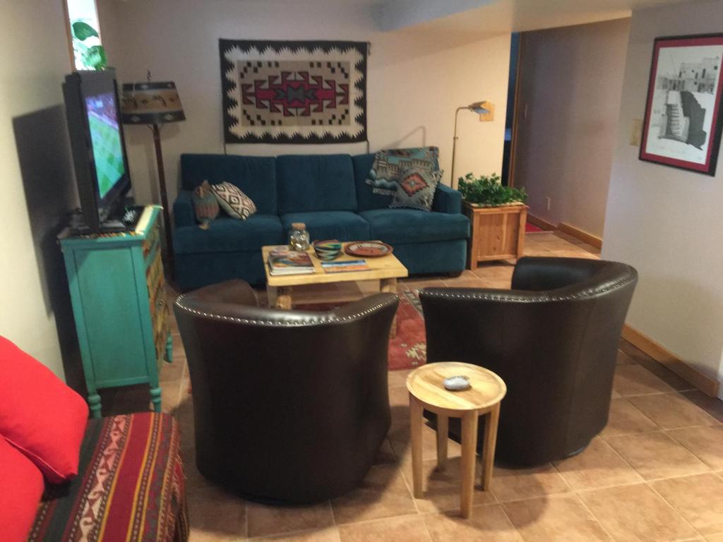 a living room with a blue couch and black chairs at 4047 Wyandot Street in Denver