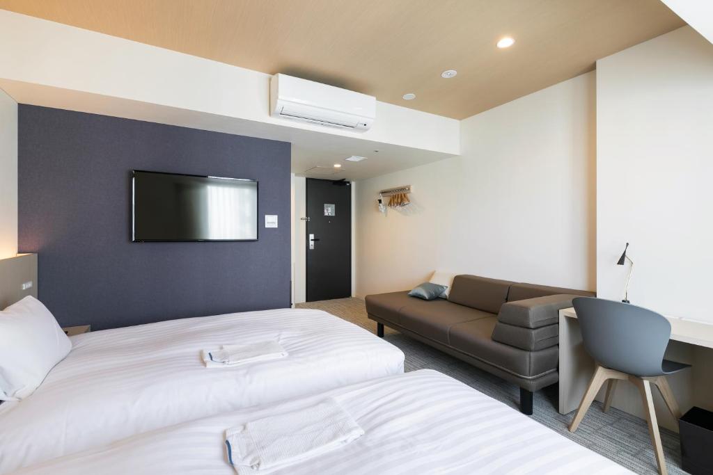 Postel nebo postele na pokoji v ubytování Ginza Capital Hotel Moegi