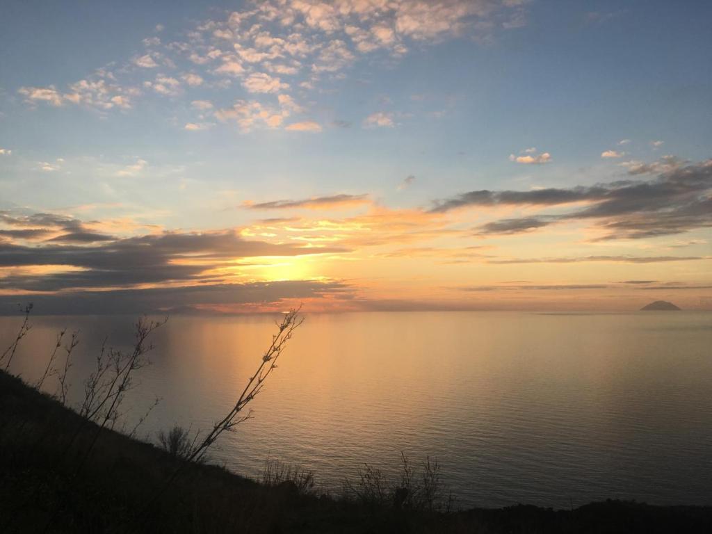 a sunset over a body of water at Country Lodge MoniGio in Quattro Pani