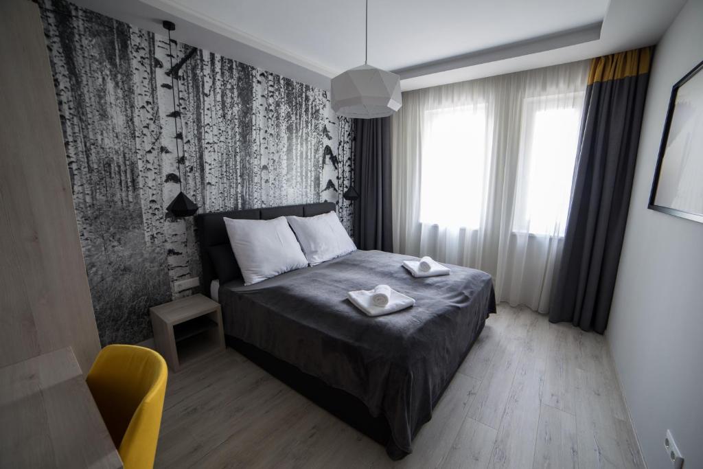 a bedroom with a bed with two towels on it at Villa Mangó in Balatongyörök