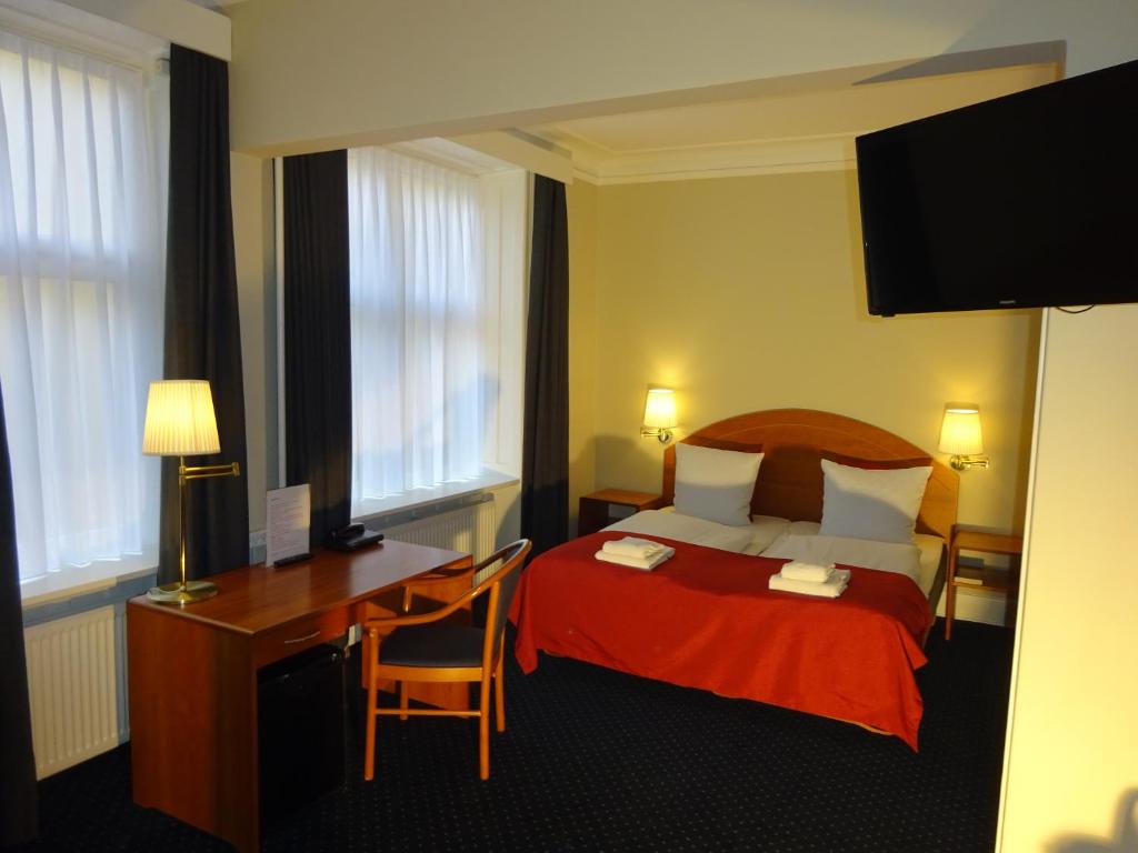 Postel nebo postele na pokoji v ubytování City Hotel Nebo