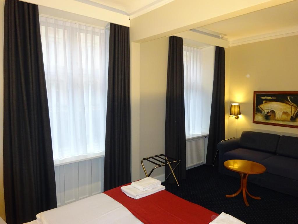 Postel nebo postele na pokoji v ubytování City Hotel Nebo