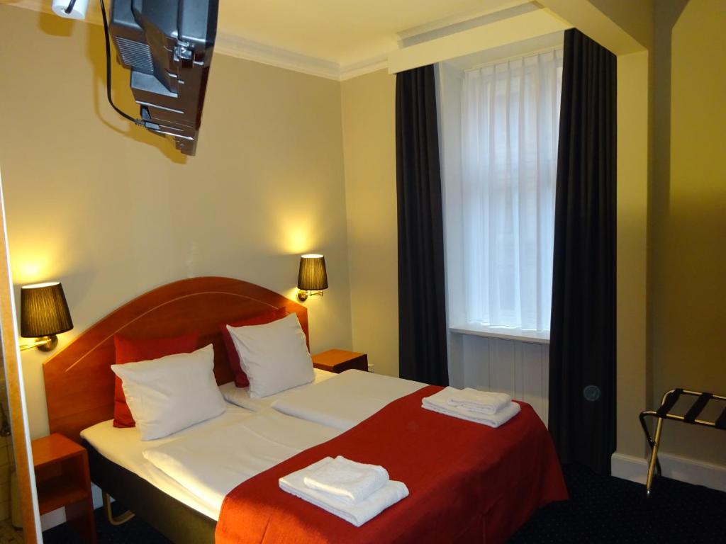 Postel nebo postele na pokoji v ubytování City Hotel Nebo