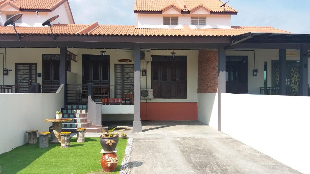 a house with a pathway leading to the front of it at TeratakMuslim H'H in Melaka