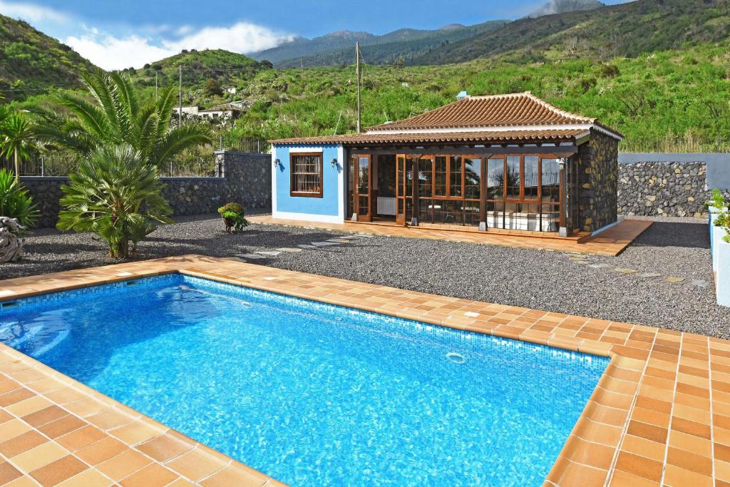 a swimming pool in front of a house at Casa Maday in Villa de Mazo