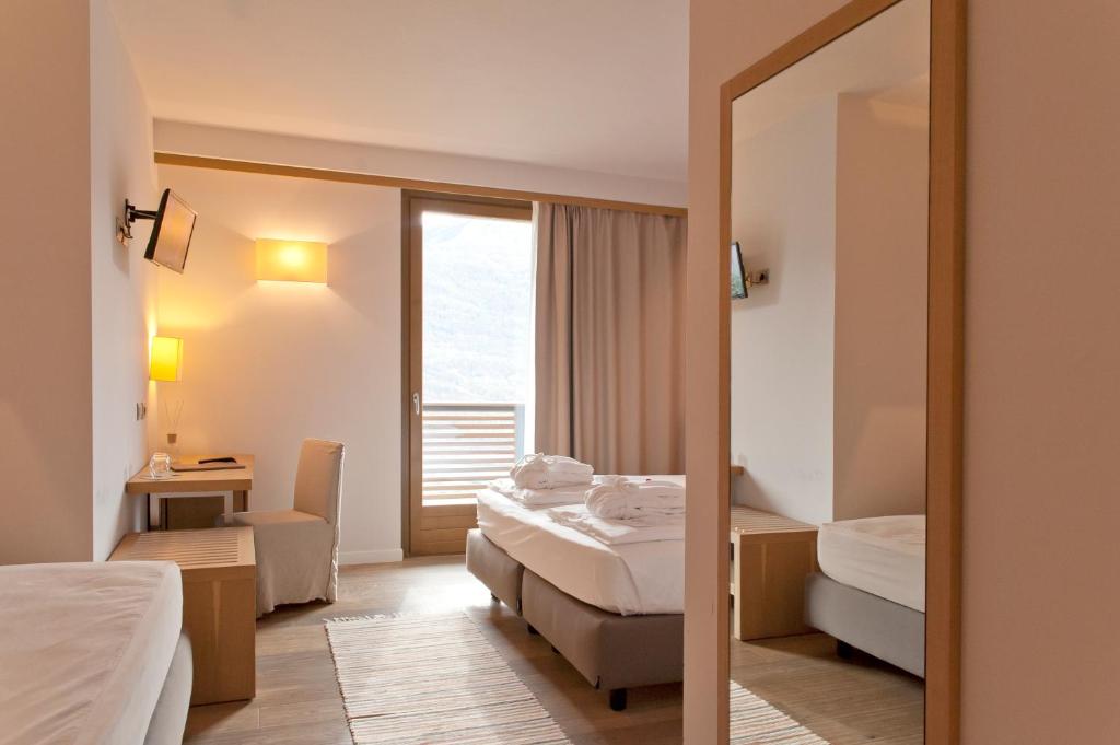 Postel nebo postele na pokoji v ubytování Wine Hotel Retici Balzi