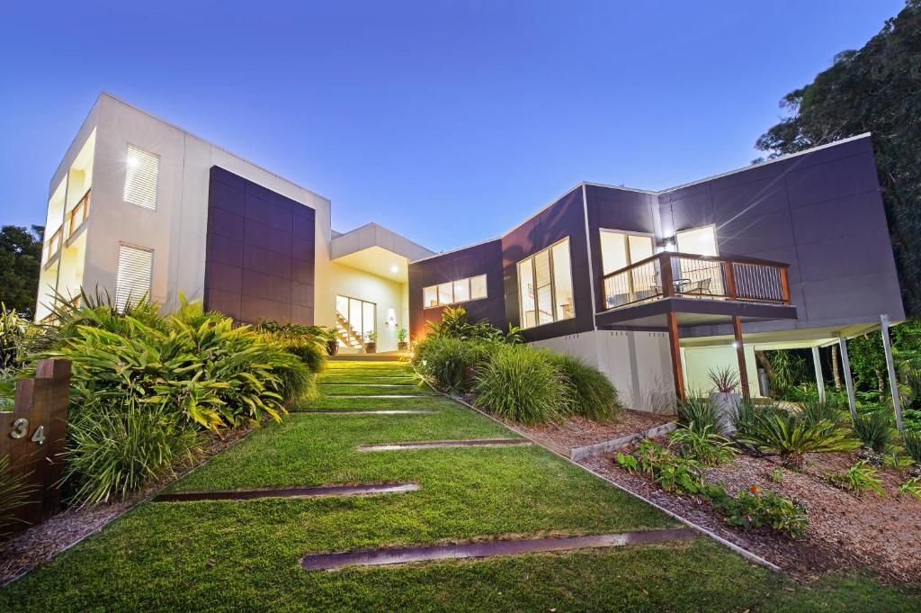 a house with a pathway leading to the front yard at Kilala - executive home in Port Macquarie