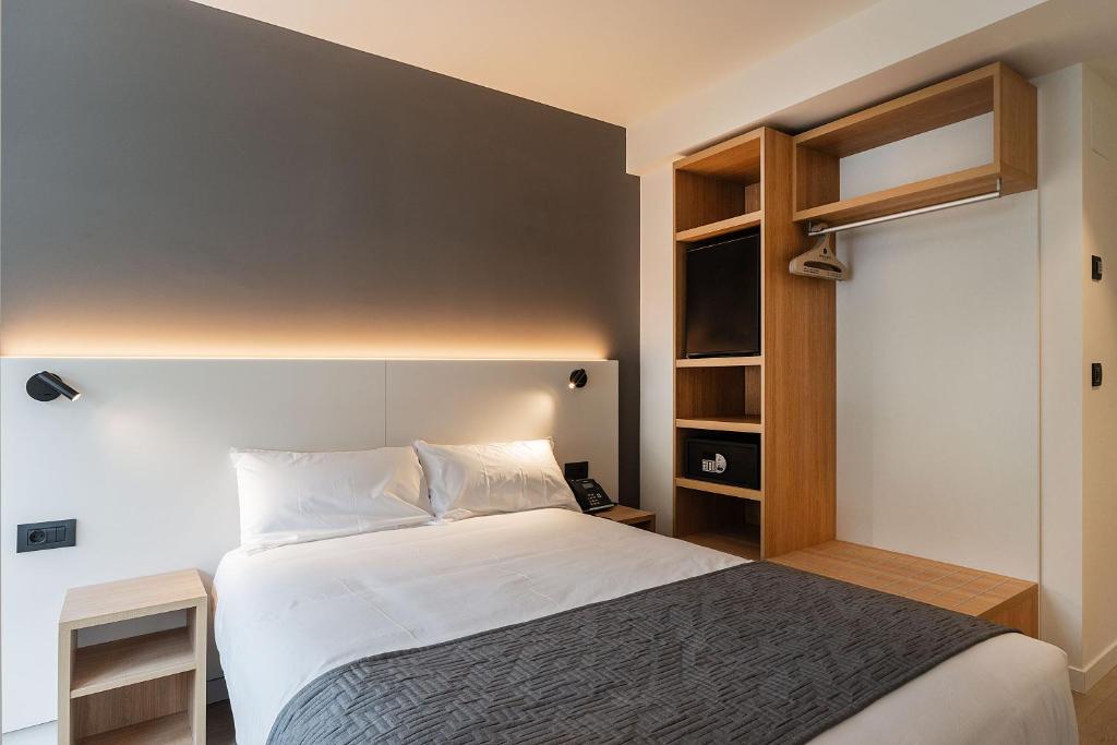 Cama o camas de una habitación en Hotel Distrito Oeste