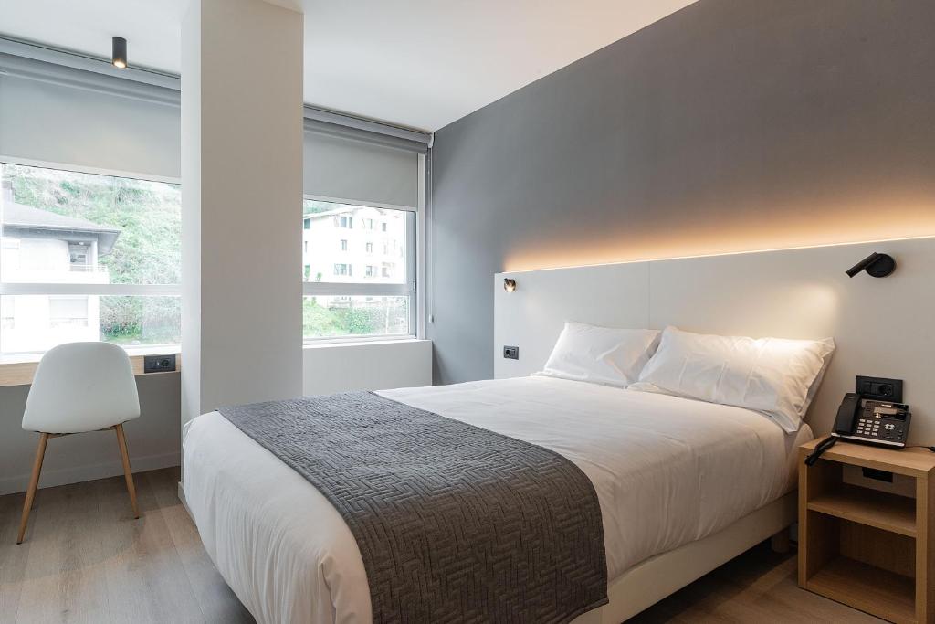 Cama o camas de una habitación en Hotel Distrito Oeste