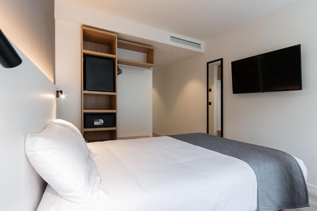 Cama o camas de una habitación en Hotel Distrito Oeste