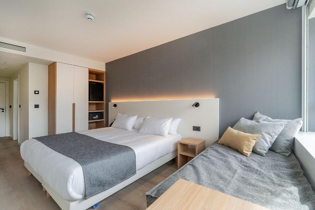 Cama o camas de una habitación en Hotel Distrito Oeste