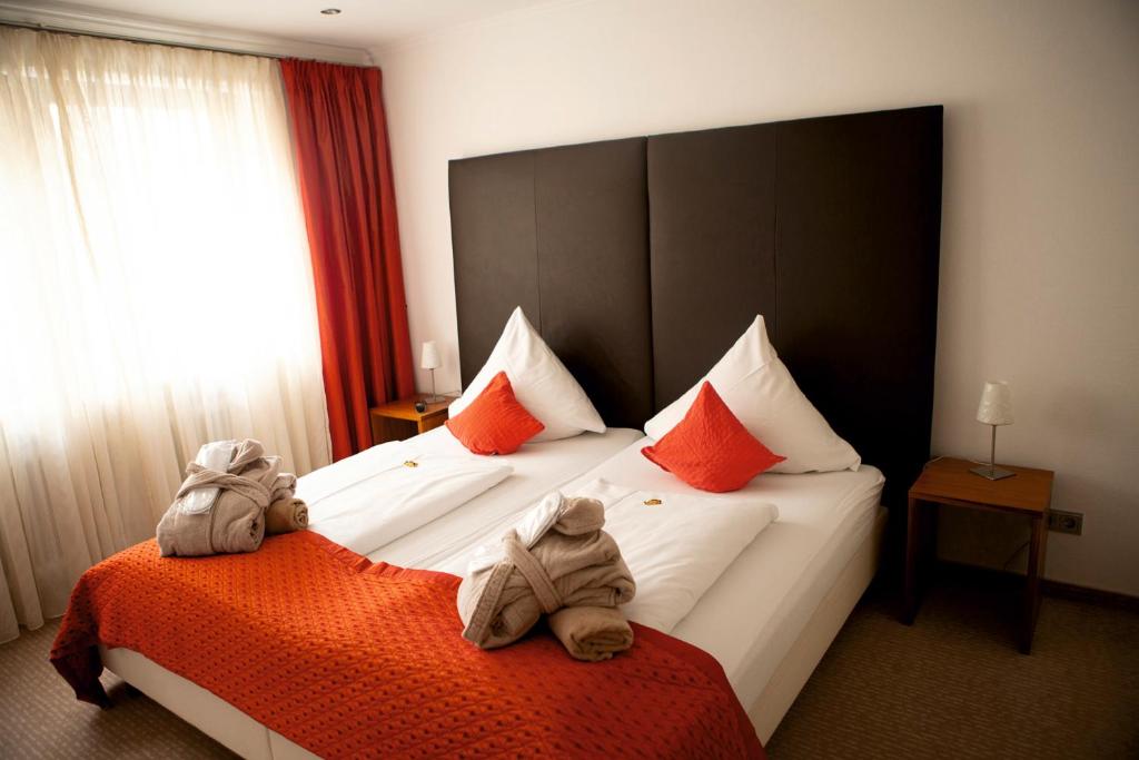 Postel nebo postele na pokoji v ubytování Arens Hotel 327mNN