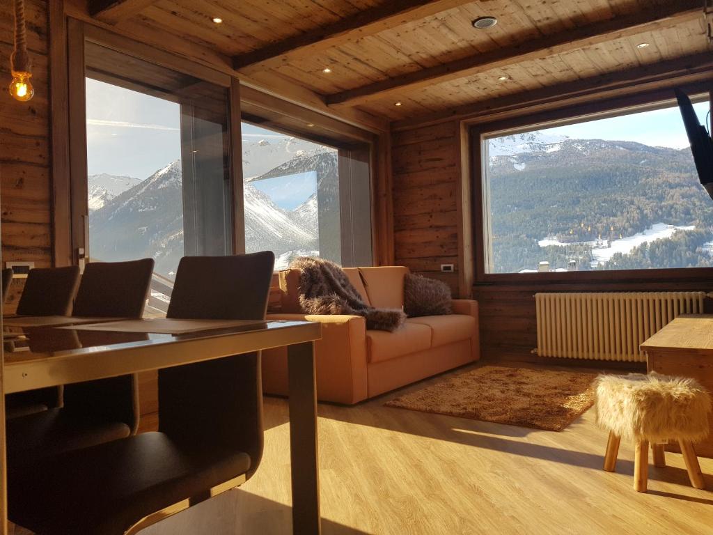 
a living room filled with furniture and a dog at Chalet Dcb in Bormio
