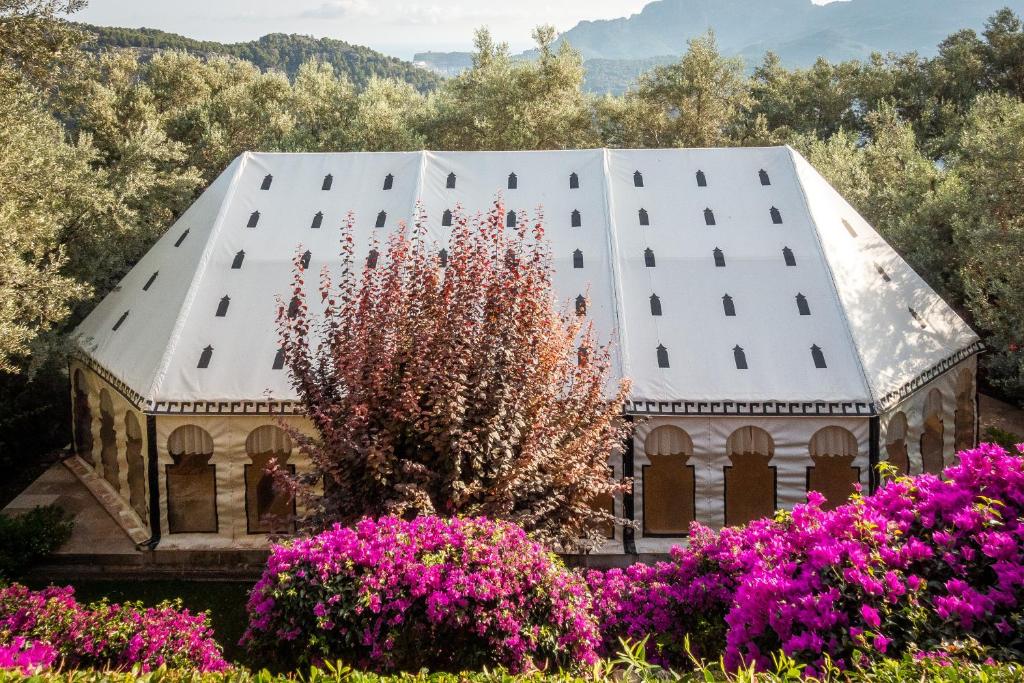 an old building with pink flowers in front of it at Ca's Xorc Luxury Retreat - ADULTS ONLY in Sóller