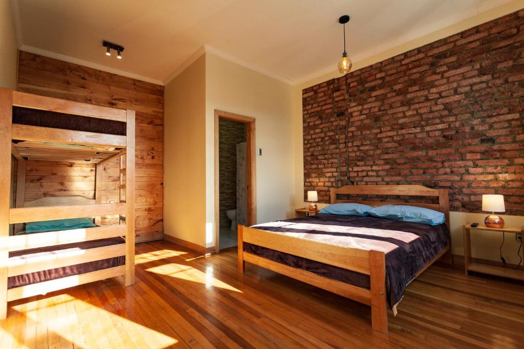 Postel nebo postele na pokoji v ubytování Hostal Boutique Patagonia Mística