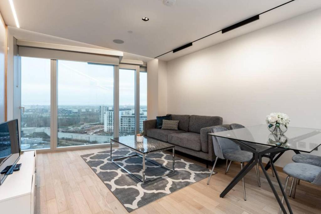 a living room with a couch and a glass table at Amazing Apartment with Incredible Views (MLG) in London