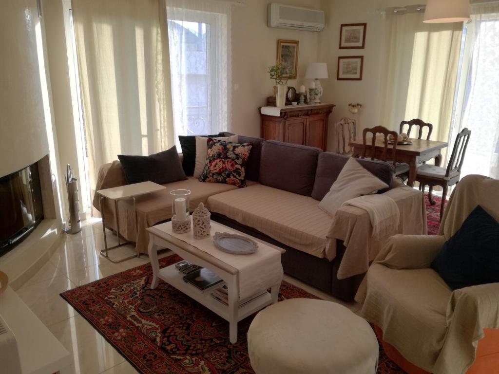 a living room with a couch and a table at Maria's House in Athens