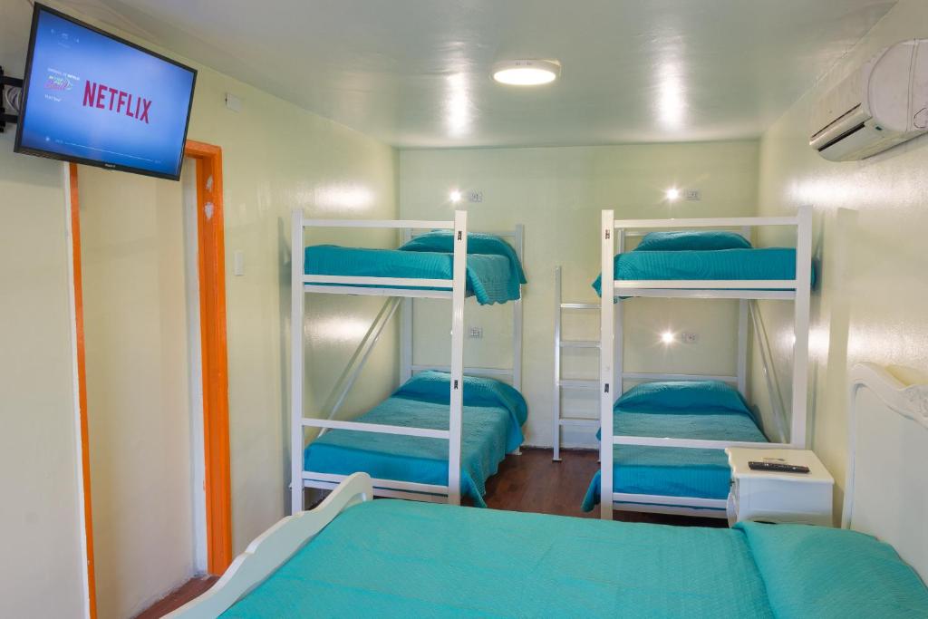 Postel nebo postele na pokoji v ubytování Hostal Casa Aborigen