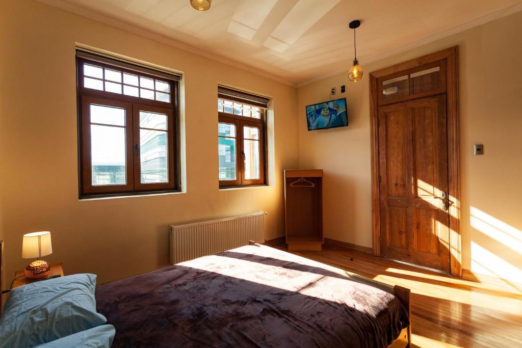 Postel nebo postele na pokoji v ubytování Hostal Boutique Patagonia Mística