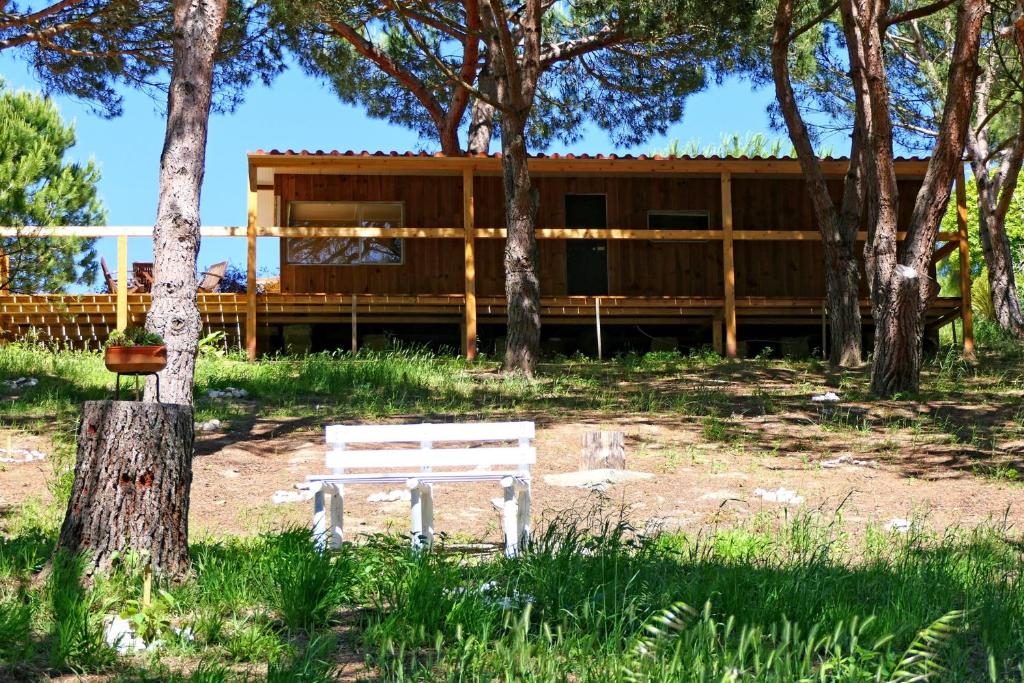 a white bench sitting in front of a house at Quinta do Meco - Beach & Nature in Aldeia do Meco