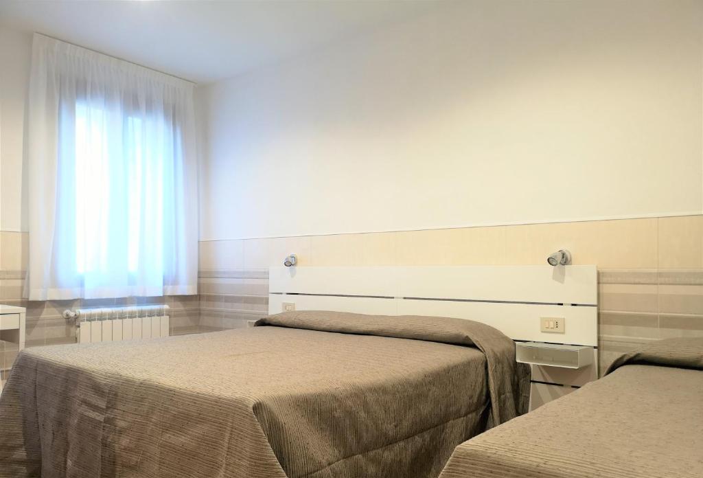Postel nebo postele na pokoji v ubytování Hotel Rossi