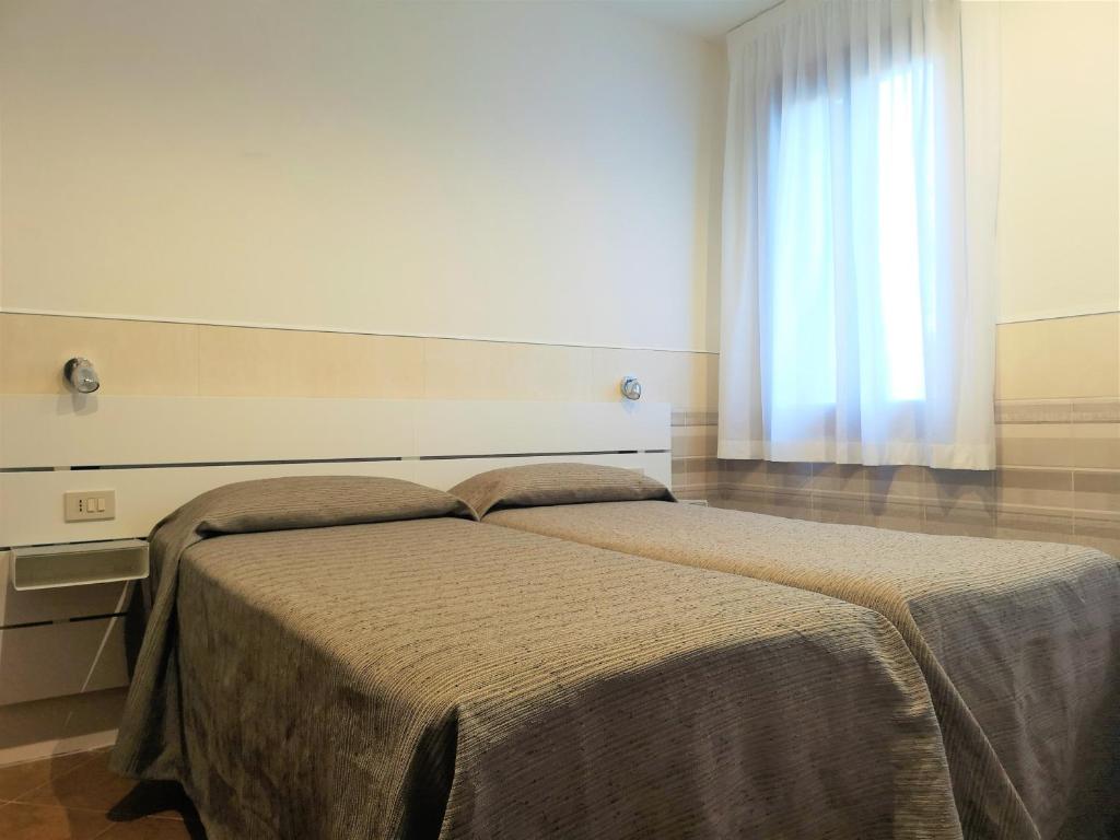 Postel nebo postele na pokoji v ubytování Hotel Rossi