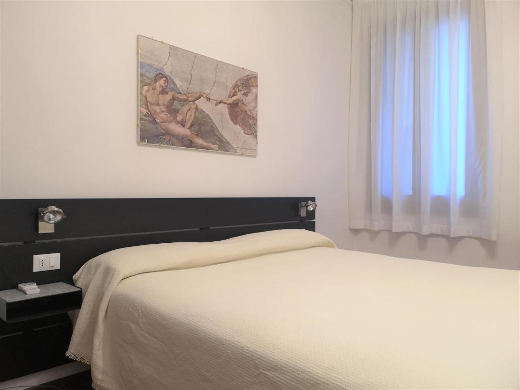 Postel nebo postele na pokoji v ubytování Hotel Rossi